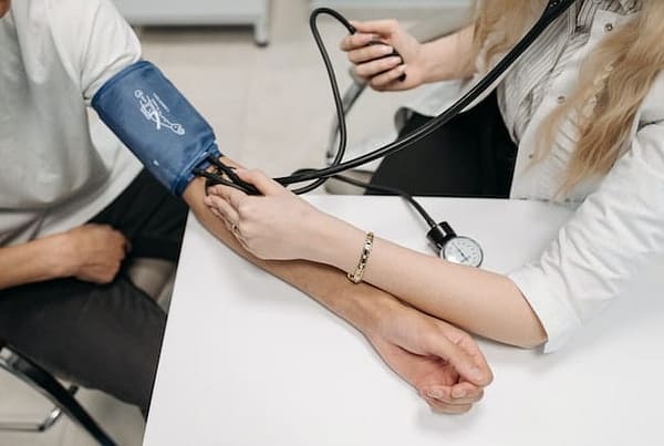 Healthcare provider checking a patient’s blood pressure