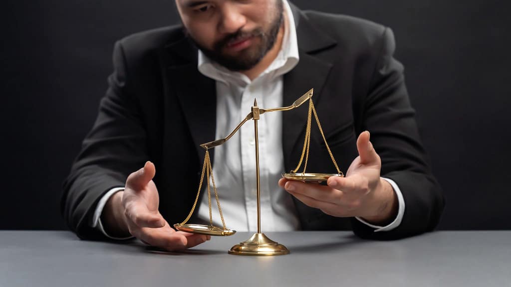man with a scale weighing pros and cons of settlements and trials