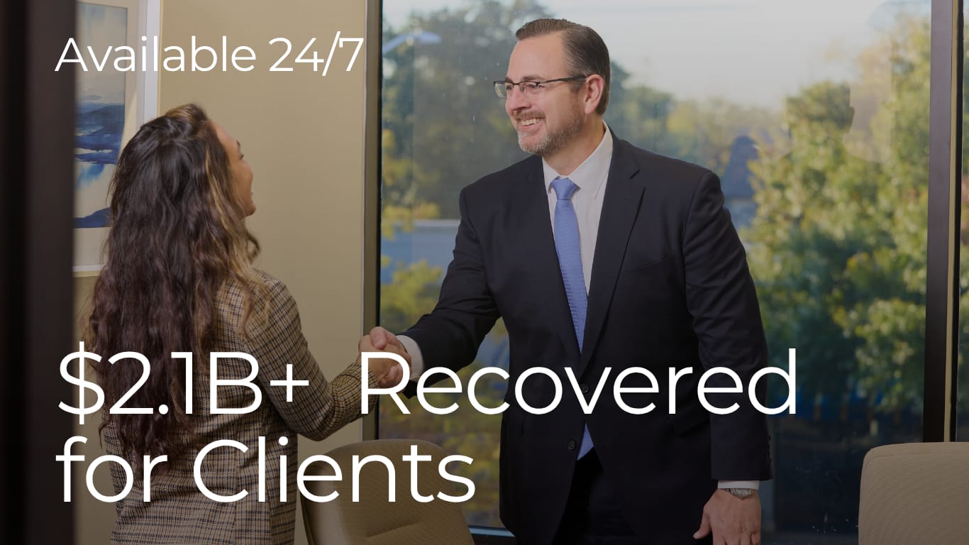 personal injury attorney shaking hands with client after successful case resolution at Thompson Law