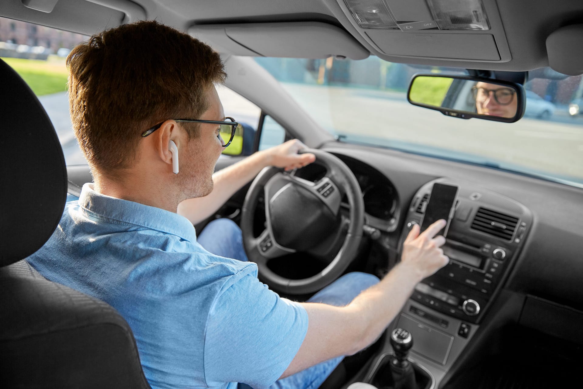 Man driving car and using headphones