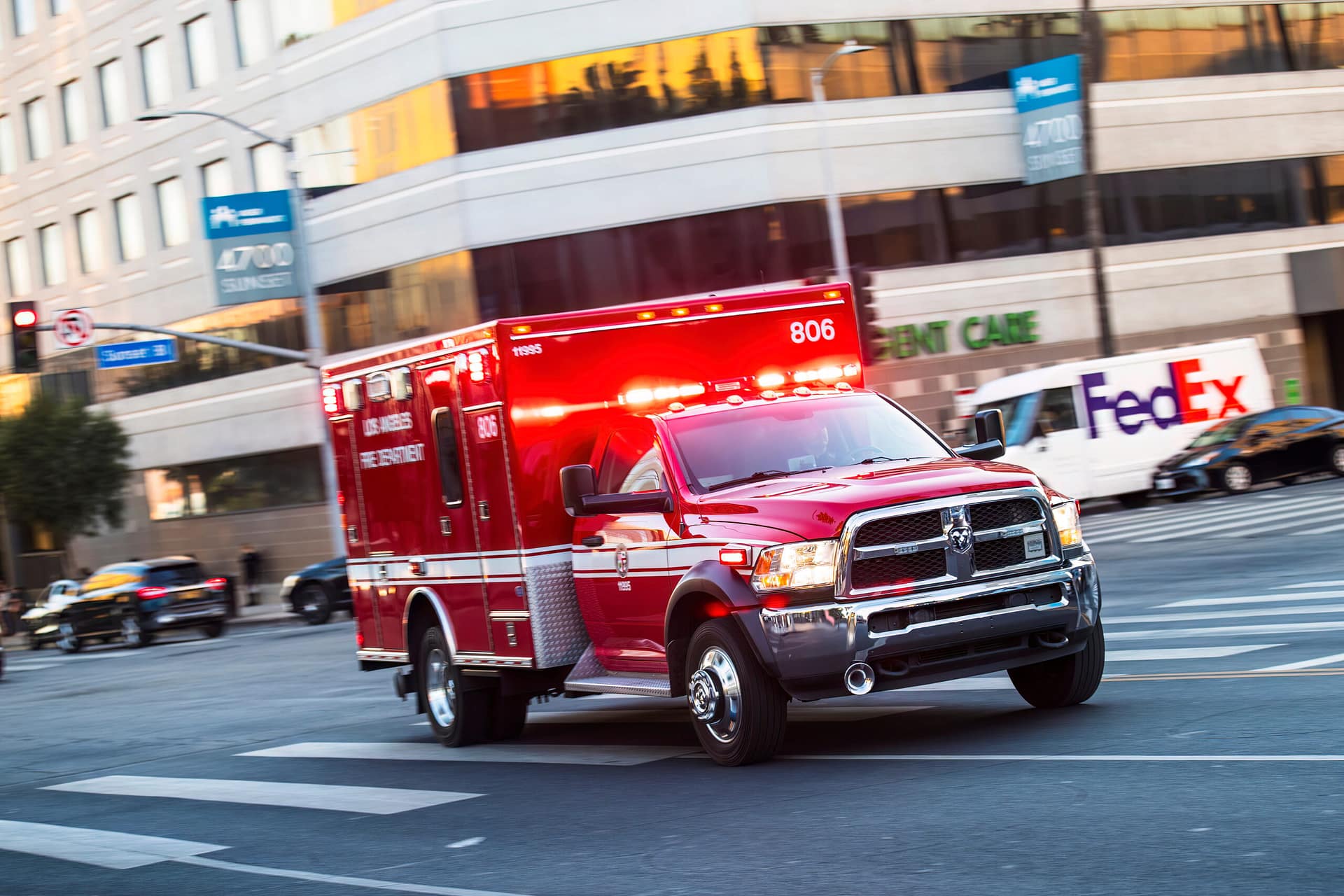 Emergency ambulance driving through Los Angeles intersection responding to a car accident scene