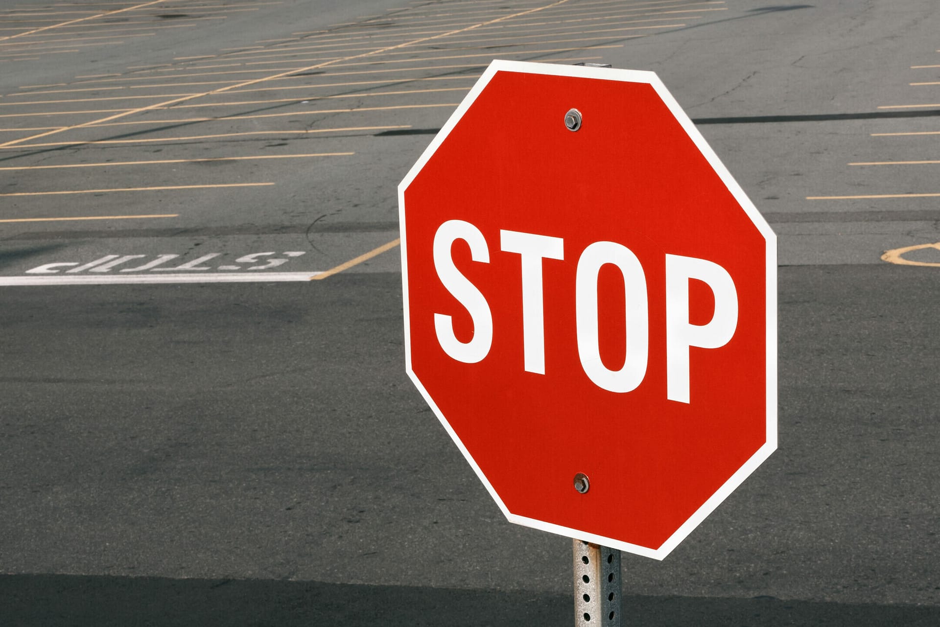Stop sign in front of parking lot