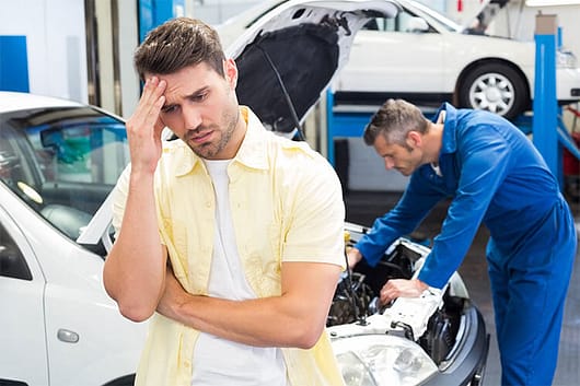 Distressed man at vehicle maintenance shop. Tips to Maintain a Car That is Rarely Driven