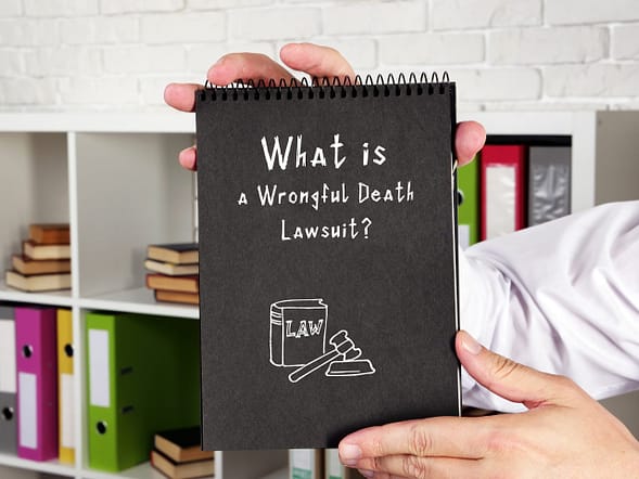 Juridical concept about a wrongful death lawsuit? with phrase on the piece of paper. El Paso wrongful death lawyers.