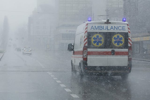 An ambulance took the patient to the clinic with the turn signals on. Bad weather outside, rain with wet snow. Ambulance chasers committing barratry.