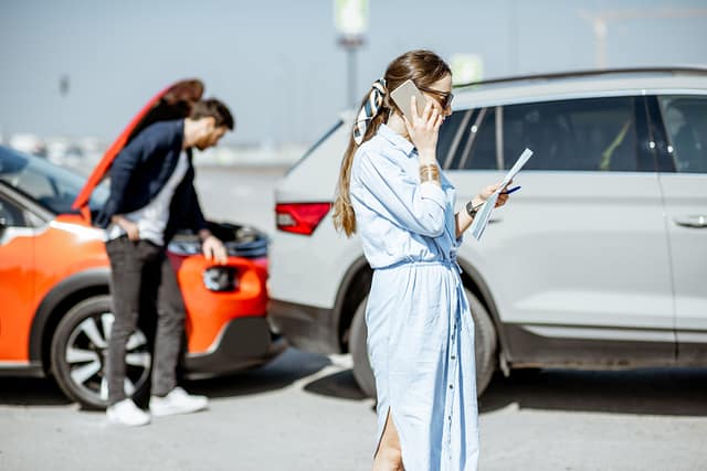 San Antonio Crash Evidence Checklist: What to Collect After an Accident 2 Driver calling for help after San Antonio car accident while another vehicle shows hood damage nearby