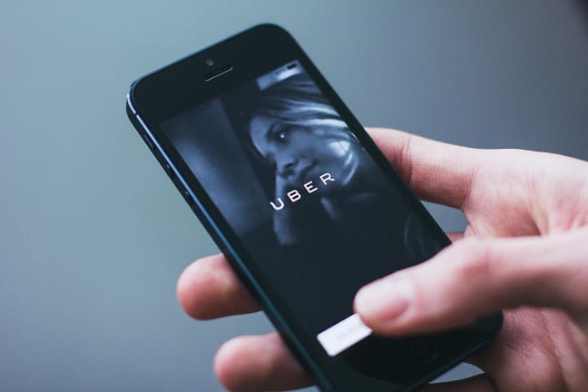 hand holding a phone - Anaheim Rideshare Accident Lawyers