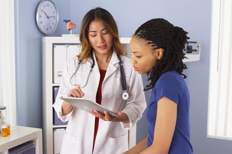 Doctor reviewing medical records with a patient after a personal injury accident