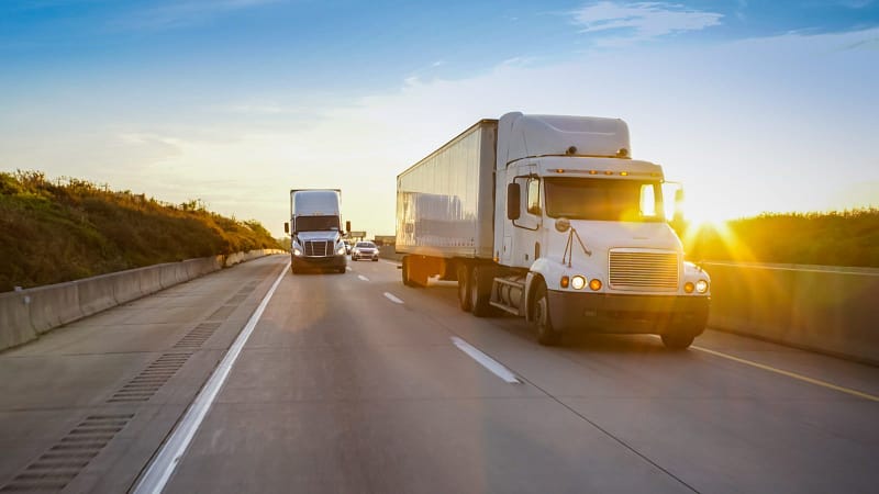 semi tractor trailer driving on the highway in the evening. Wichita Falls Truck Accident Lawyers 