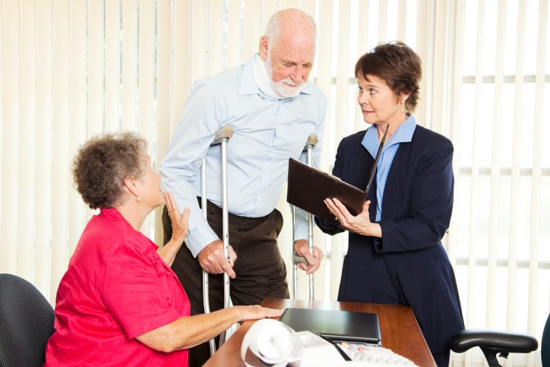 Injured man and his wife meet with a personal injury lawyer.