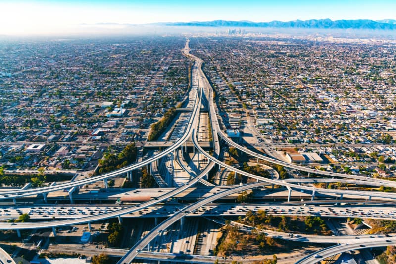 Aerial view of a Los Angeles freeway interchange and downtown skyline, representing common crash locations across LA highways
